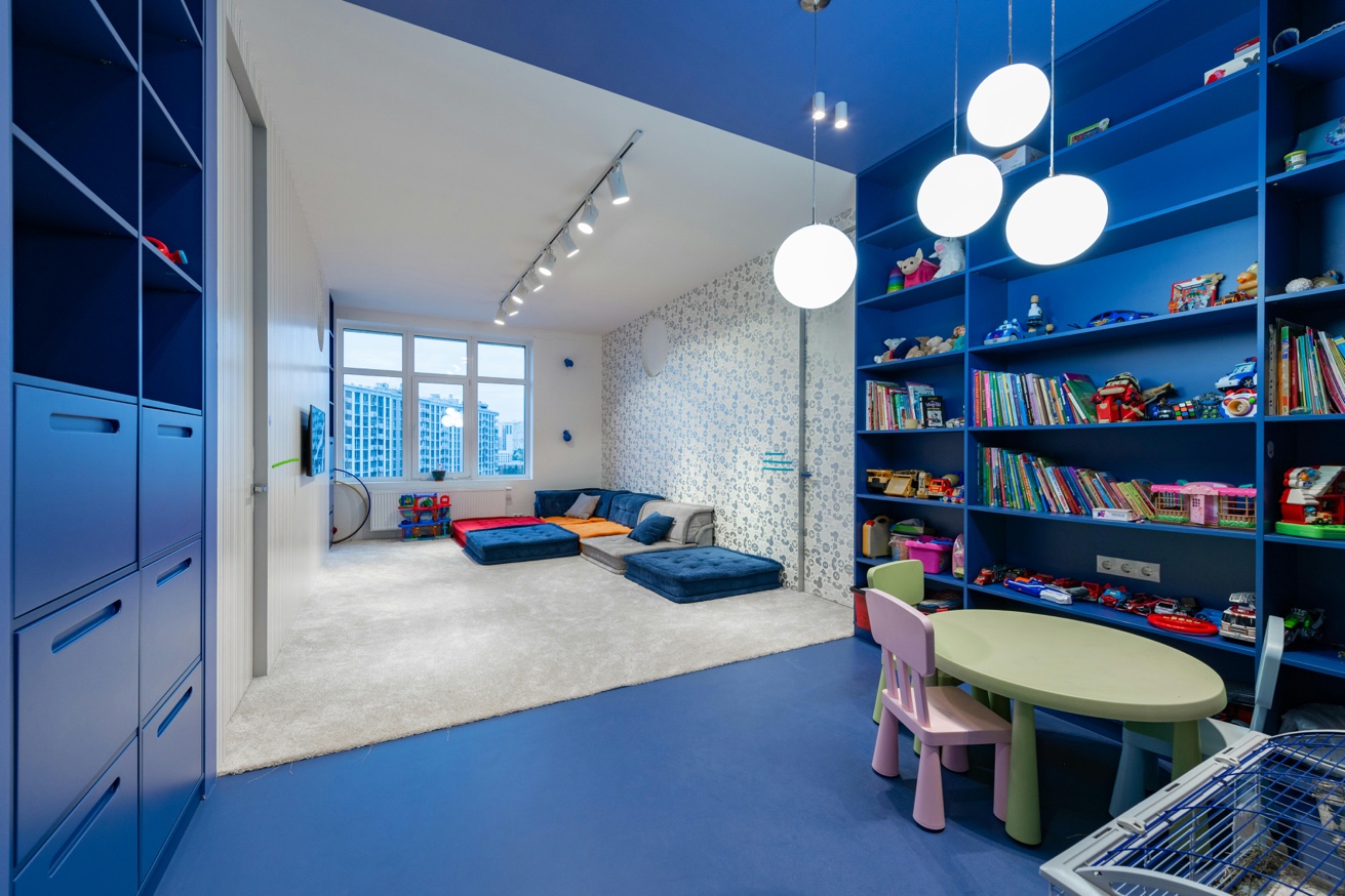 Colorful organized playroom with shelving and kids table